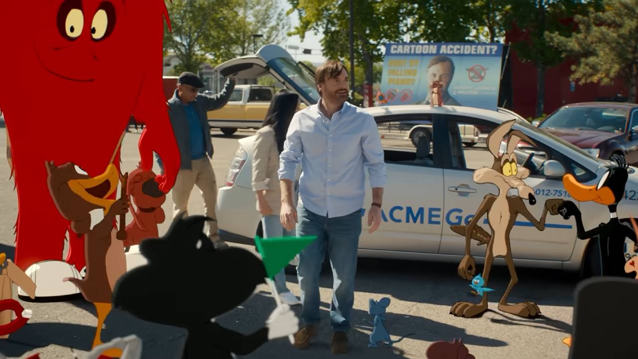 Looney Tunes characters surround a man, looking happy