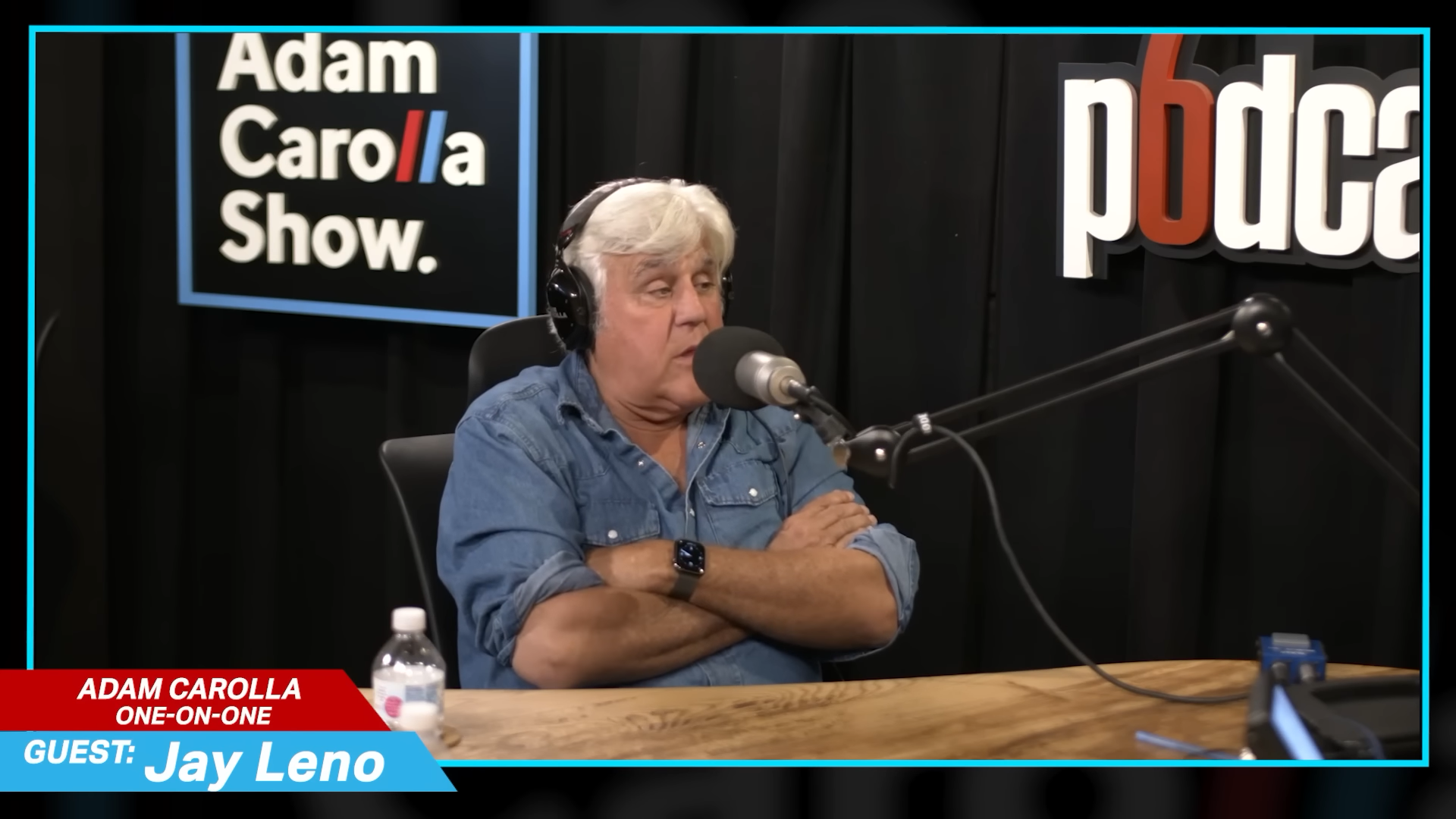 Jay Leno seated for a podcast interview
