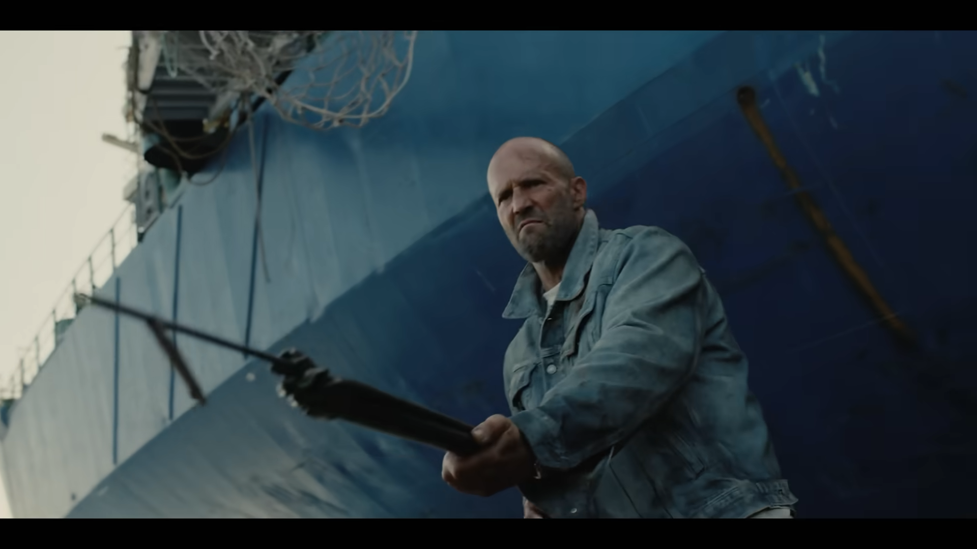 A man braces himself as he prepares to fire a harpoon gun