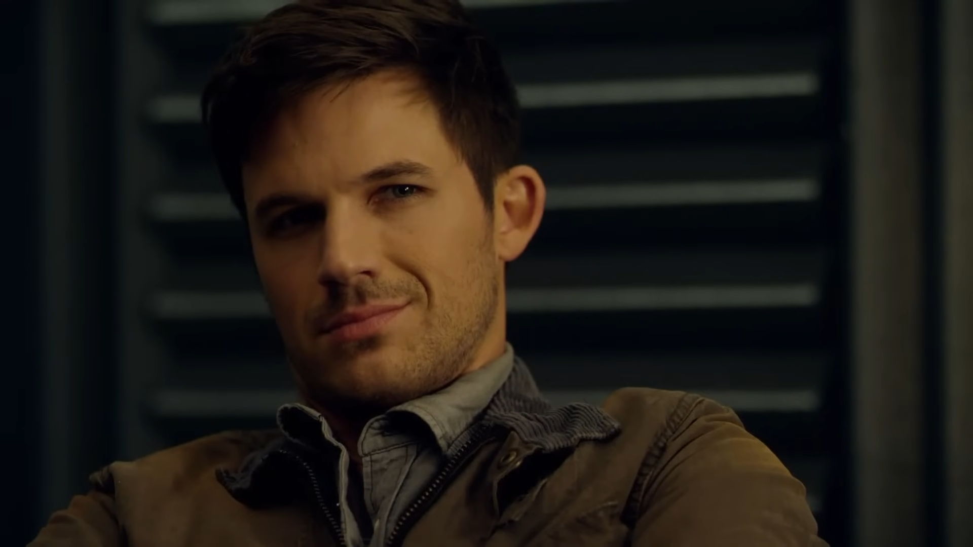 A man giving a sly smile
