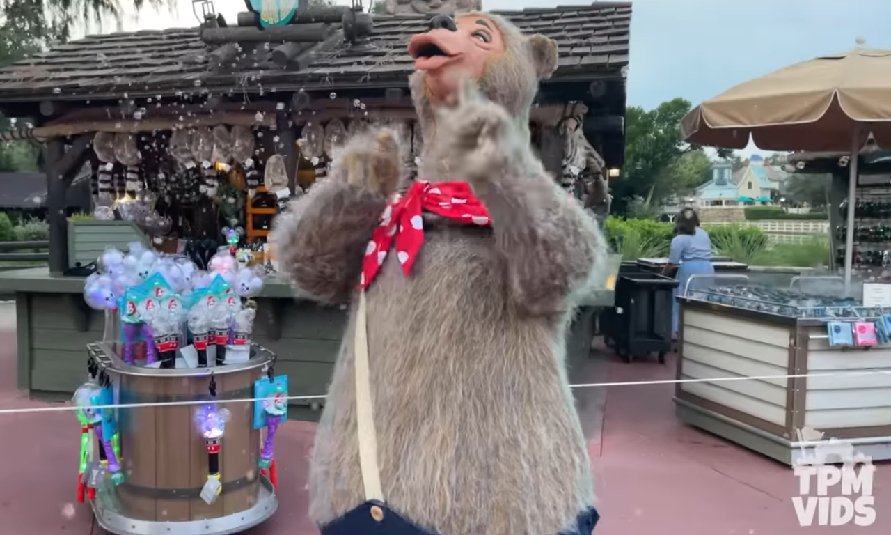 Large light brown bear costume popping bubbles