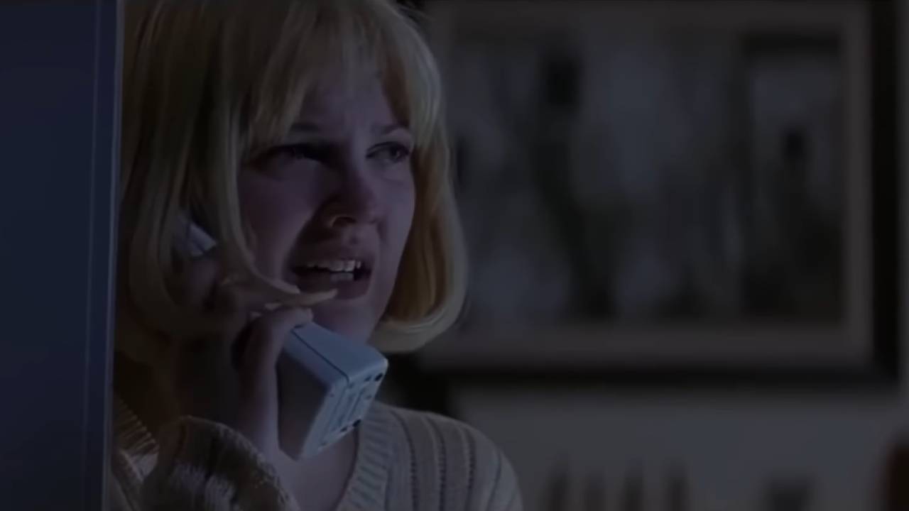 A young woman crying into a cordless phone