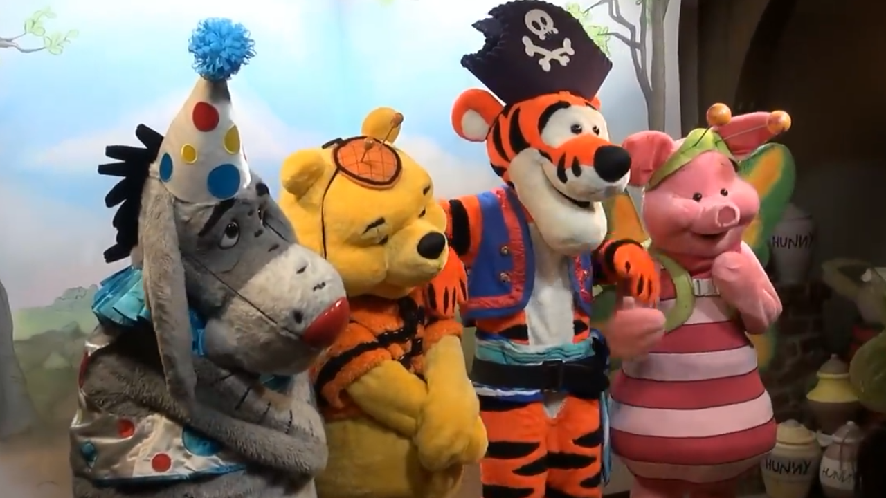Eeyore as a clown, Pooh as a bumblebee, Tigger as a pirate, and Piglet as a butterfly