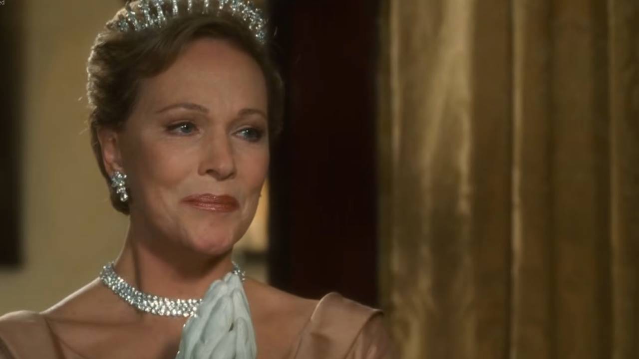 Julie Andrews, hands pressed together, looking proud