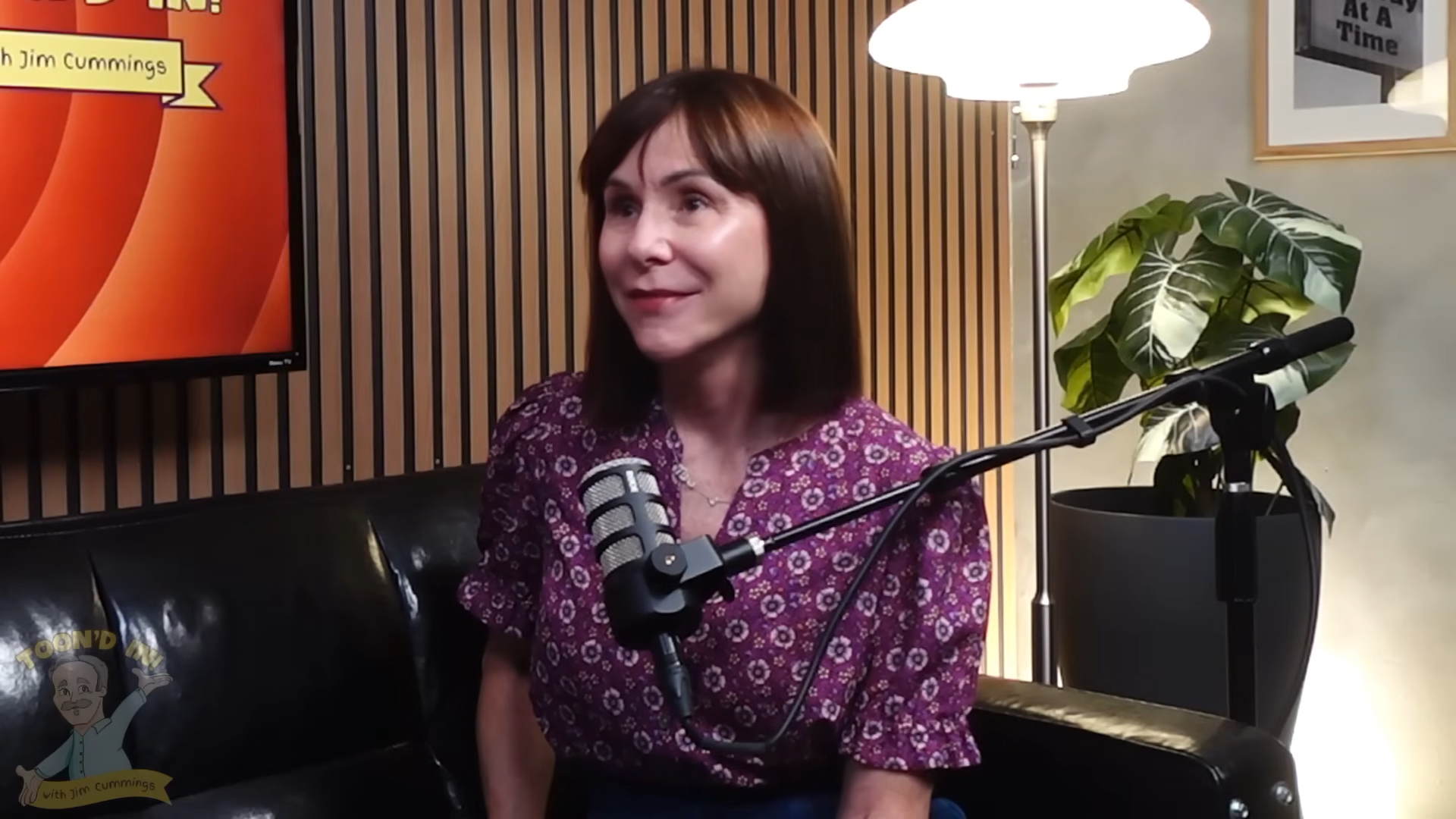 Susan Egan seated for a podcast interview