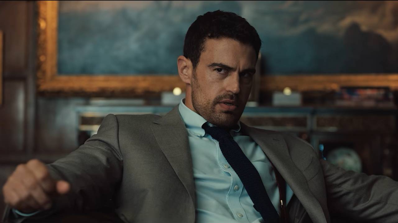 A man in a lavish room scowls