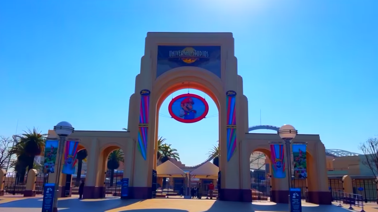 Large arch against blue sky with Mario sign handing underneath