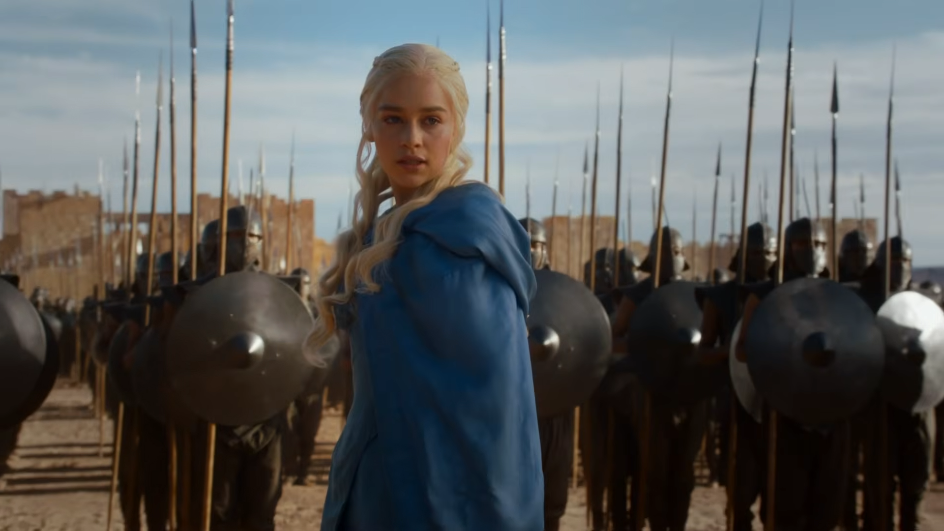 A woman stands confidently with an army at her back