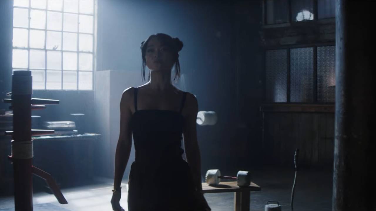 A proud woman stands in martial arts gym