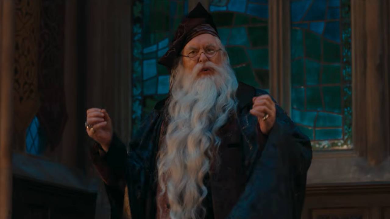 Dumbledore with his hands raised, squinting
