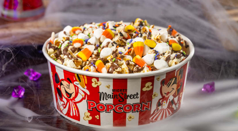 Bucket of popcorn with chocolate drizzle and candy
