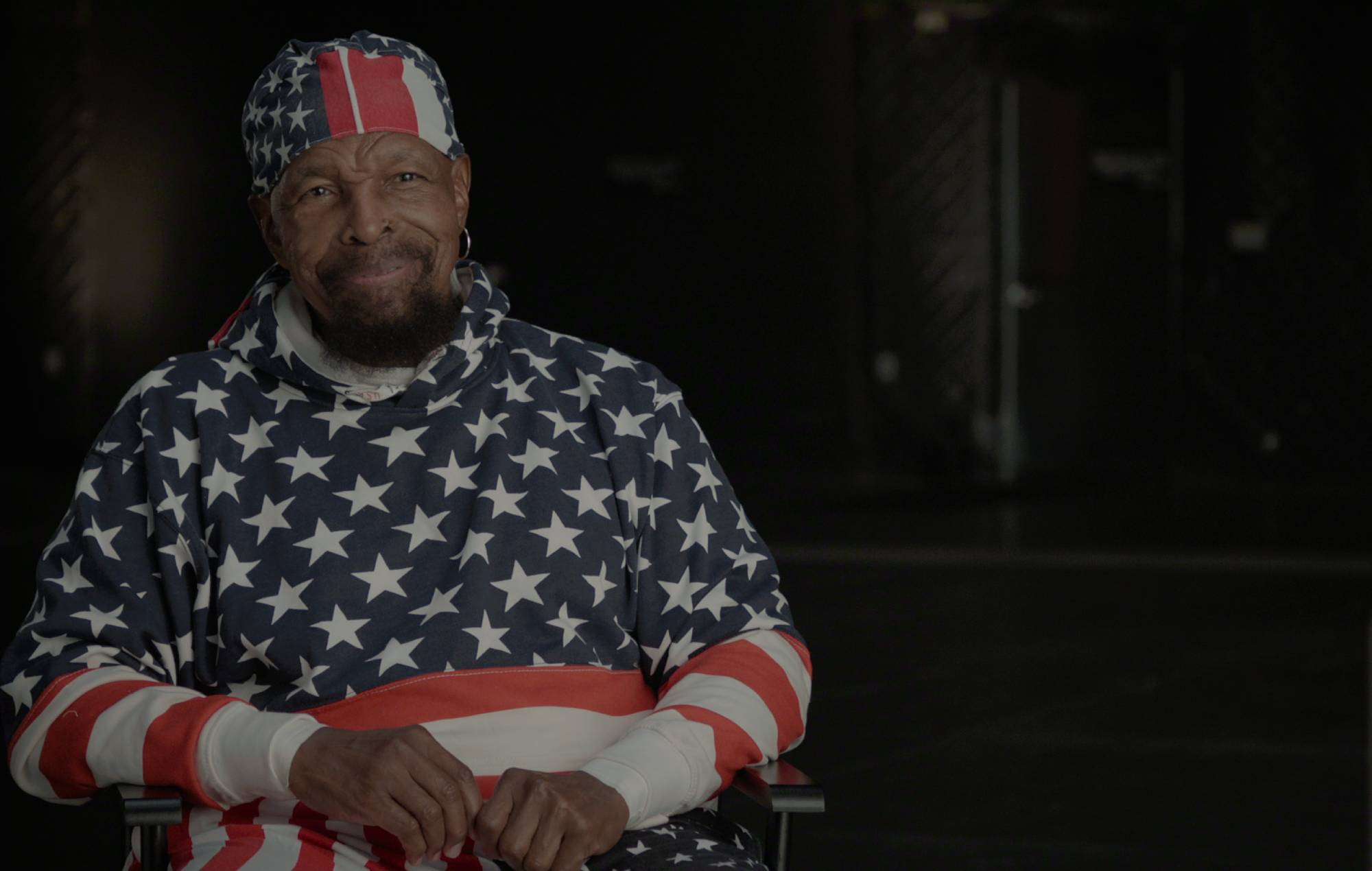 Mr T in red, white, and blue being interviewed for his Netflix documentary