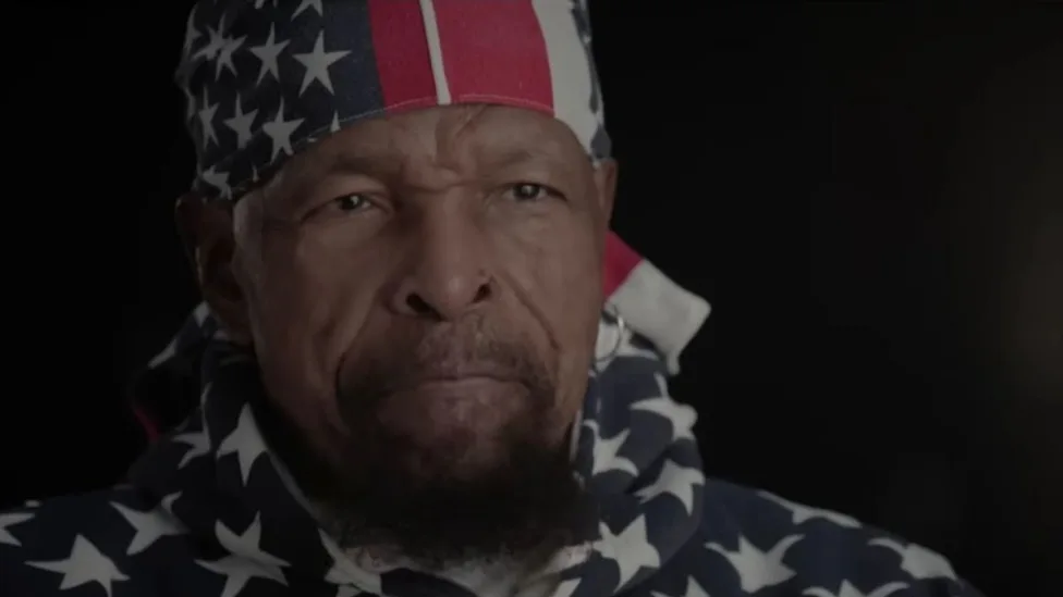 A close up of Mr T in red, white, and blue being interviewed for his Netflix documentary