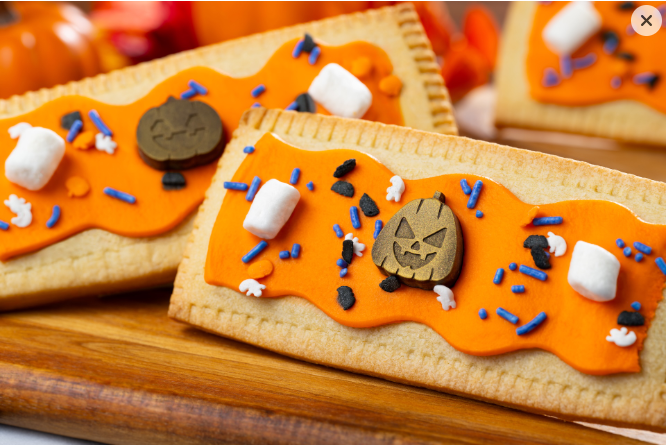 Tart with orange icing and Halloween sprinkles