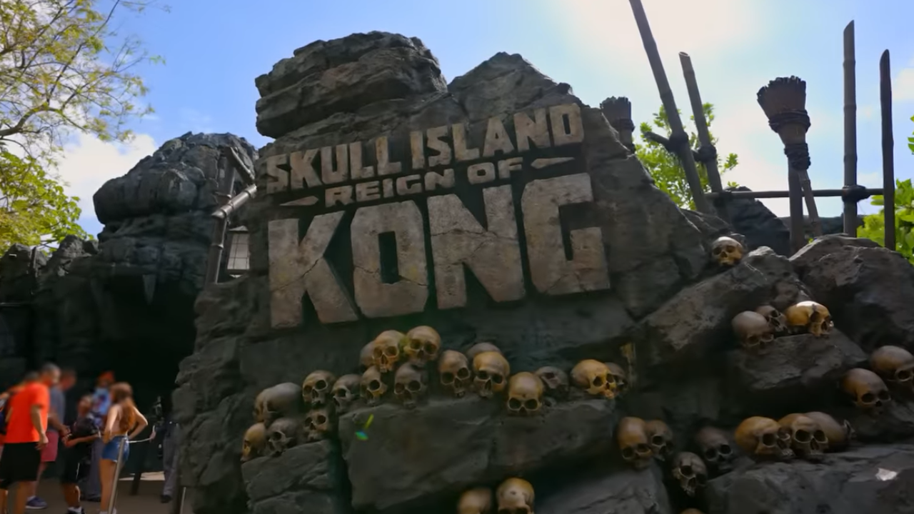 Large rock sign with several skulls as theming