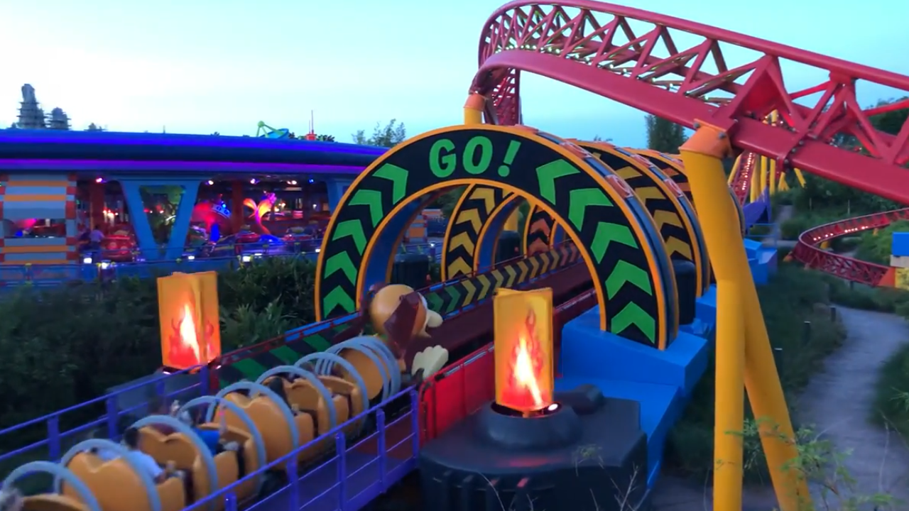 Roller coaster train about to enter arch labeled "Go!"
