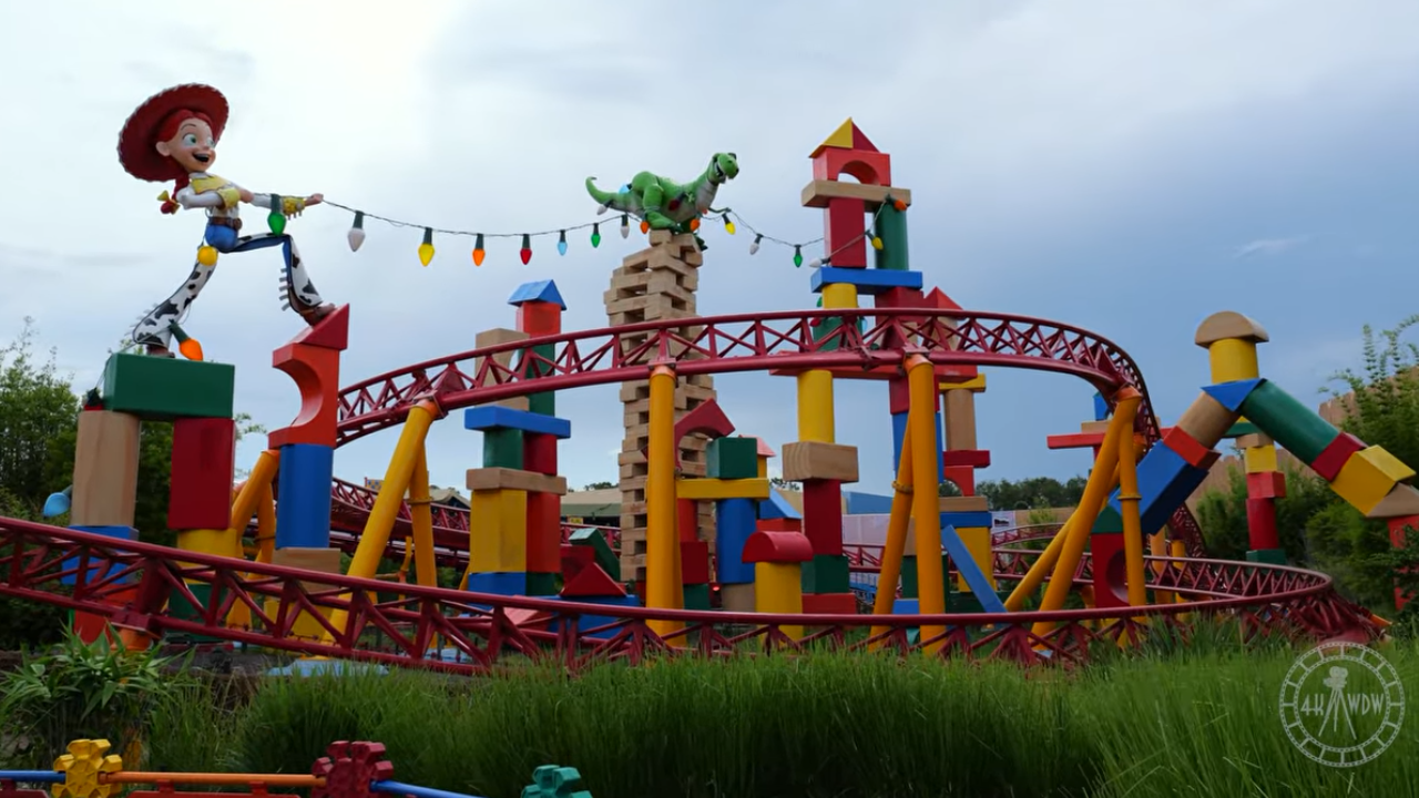 Slinky Dog Dash Red roller coaster tracks with large Jessie and Rex statues
