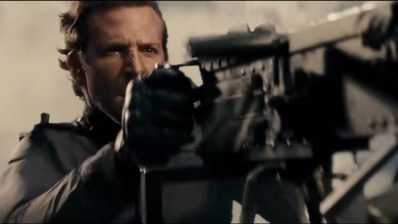 A man firing a mounted machine gun