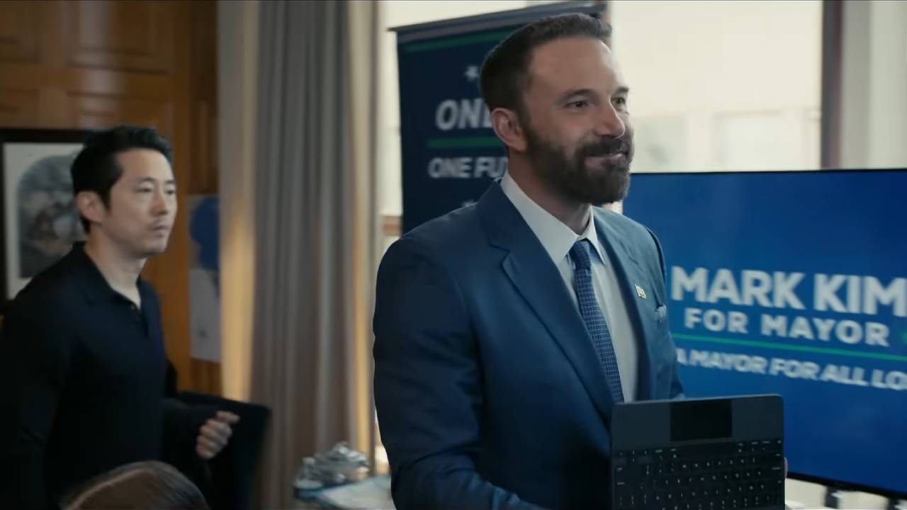 A politician walks through his campaign headquarters, smiling