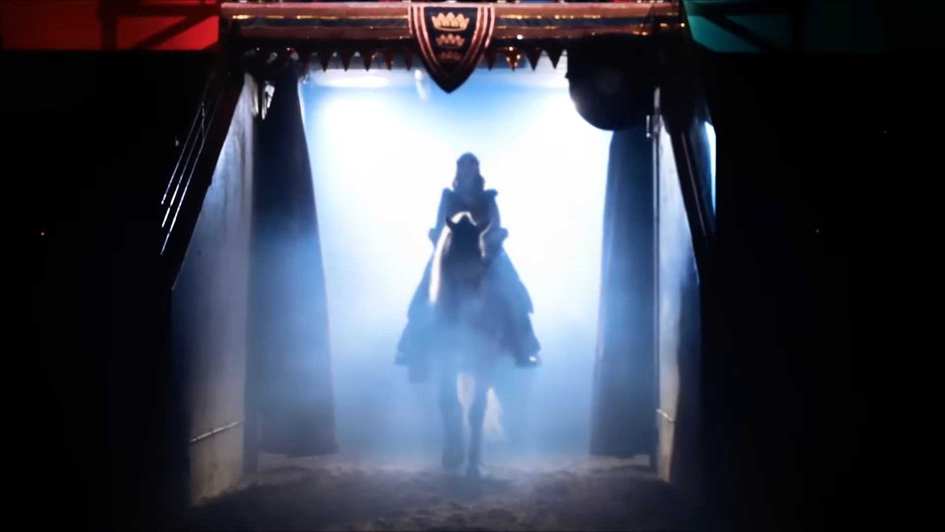 A rider on horseback enters an arena