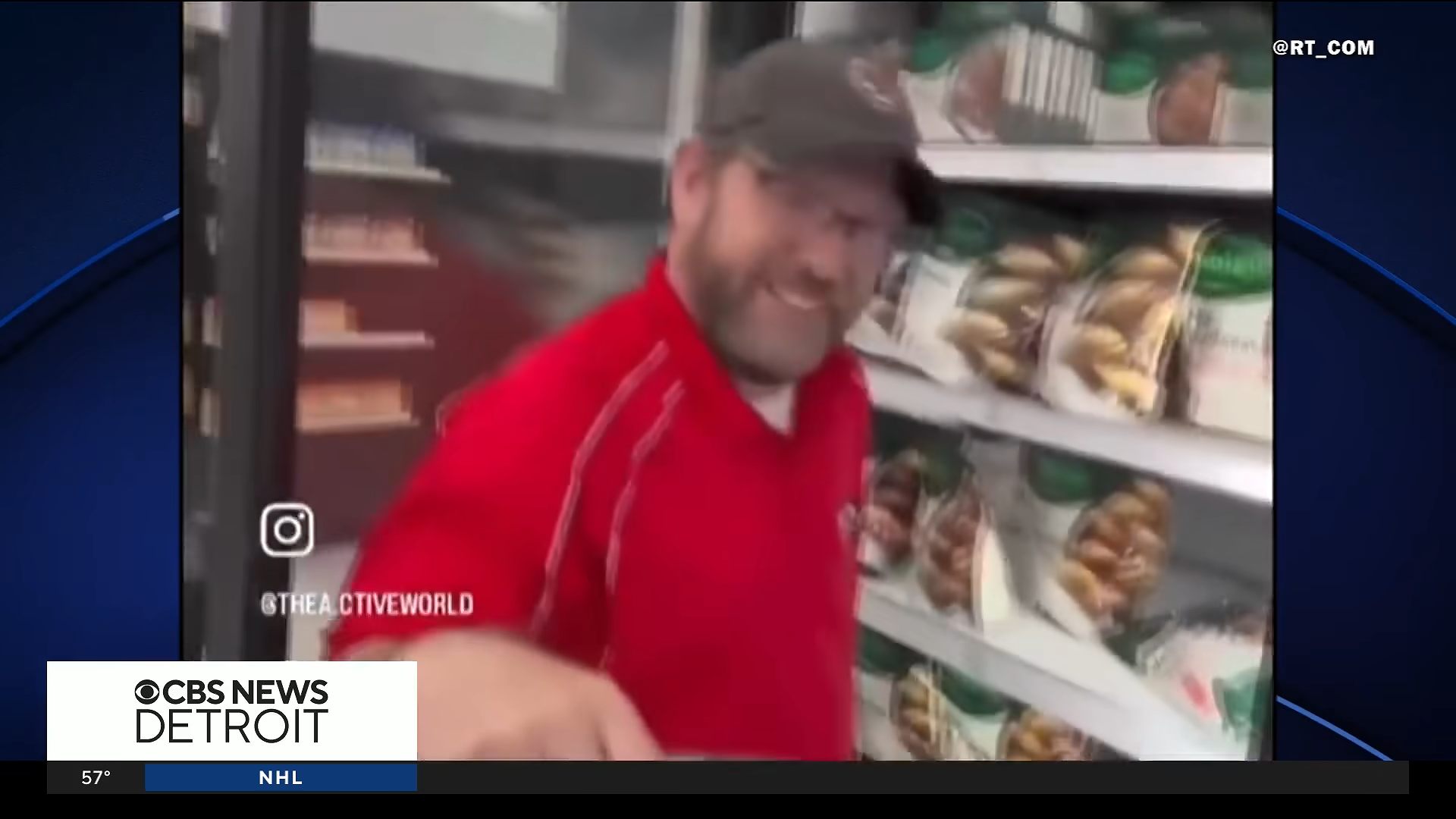 News clip of a man in a hat and red polo standing in front of a grocery store freezer case