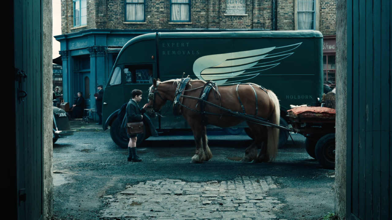 A horse stands beside a truck, giving the impression that it has wings