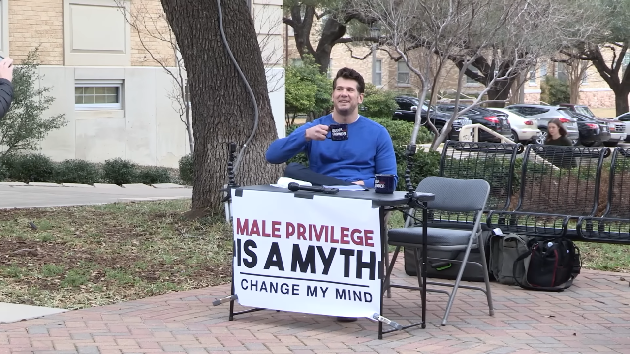 Steven Crowder seated at an outdoor table