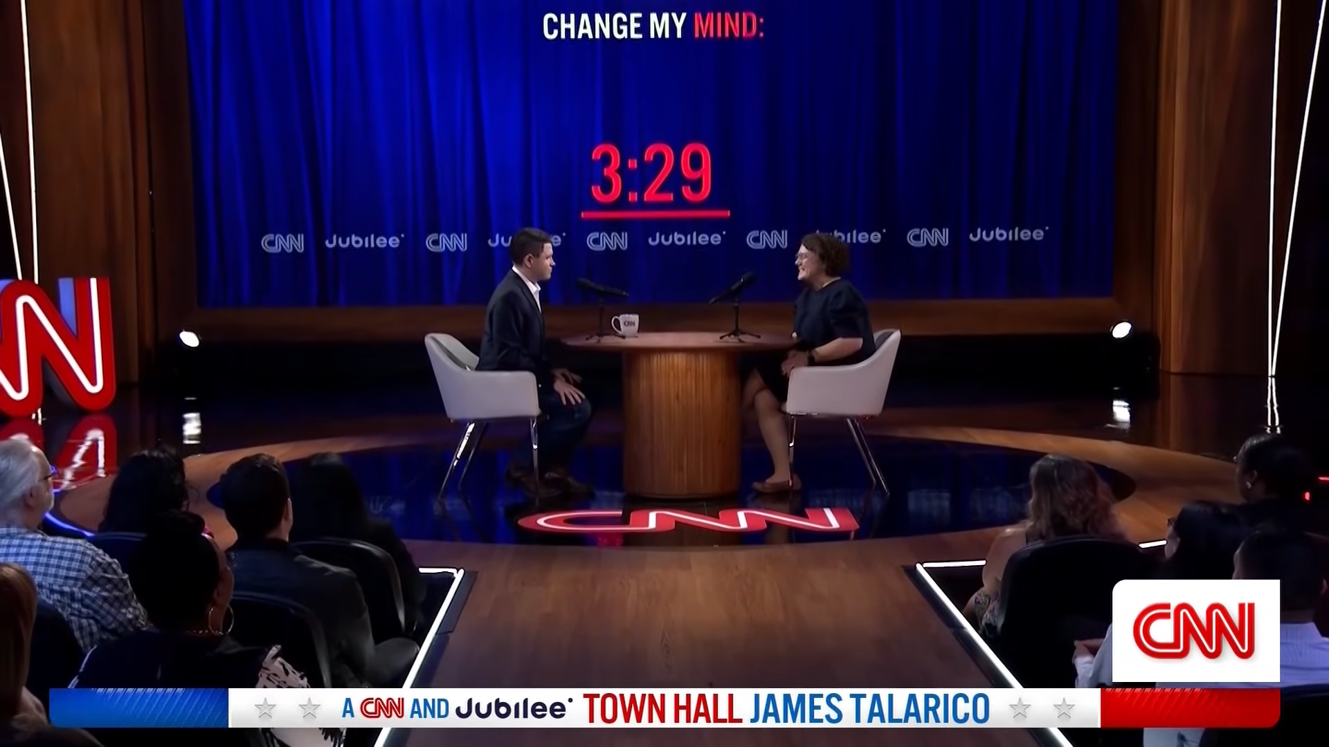 James Talarico and an audience member seated on a stage