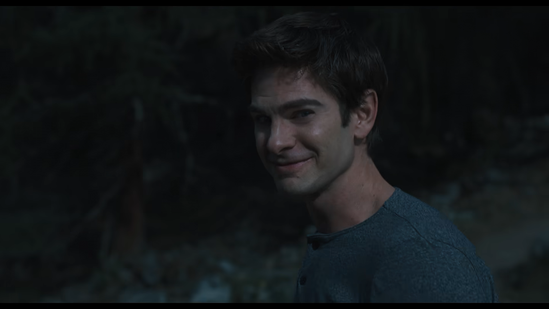 Andrew Garfield giving a wincing smile