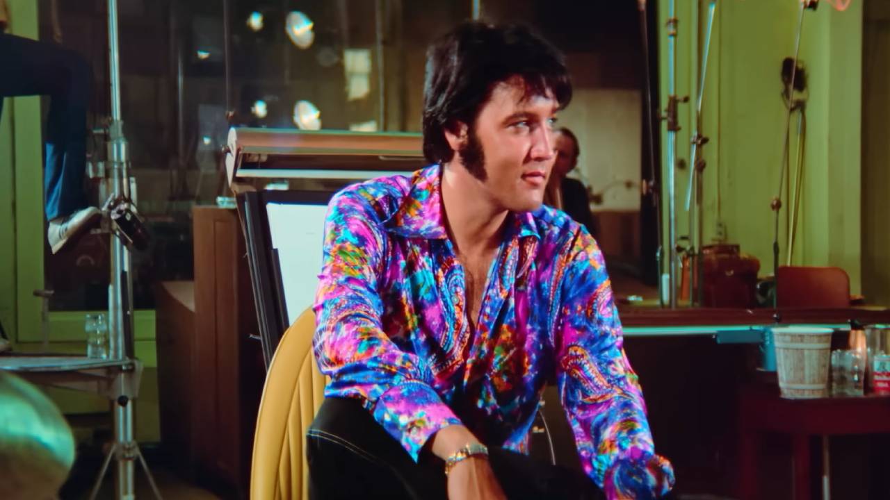 Elvis seated and smiling