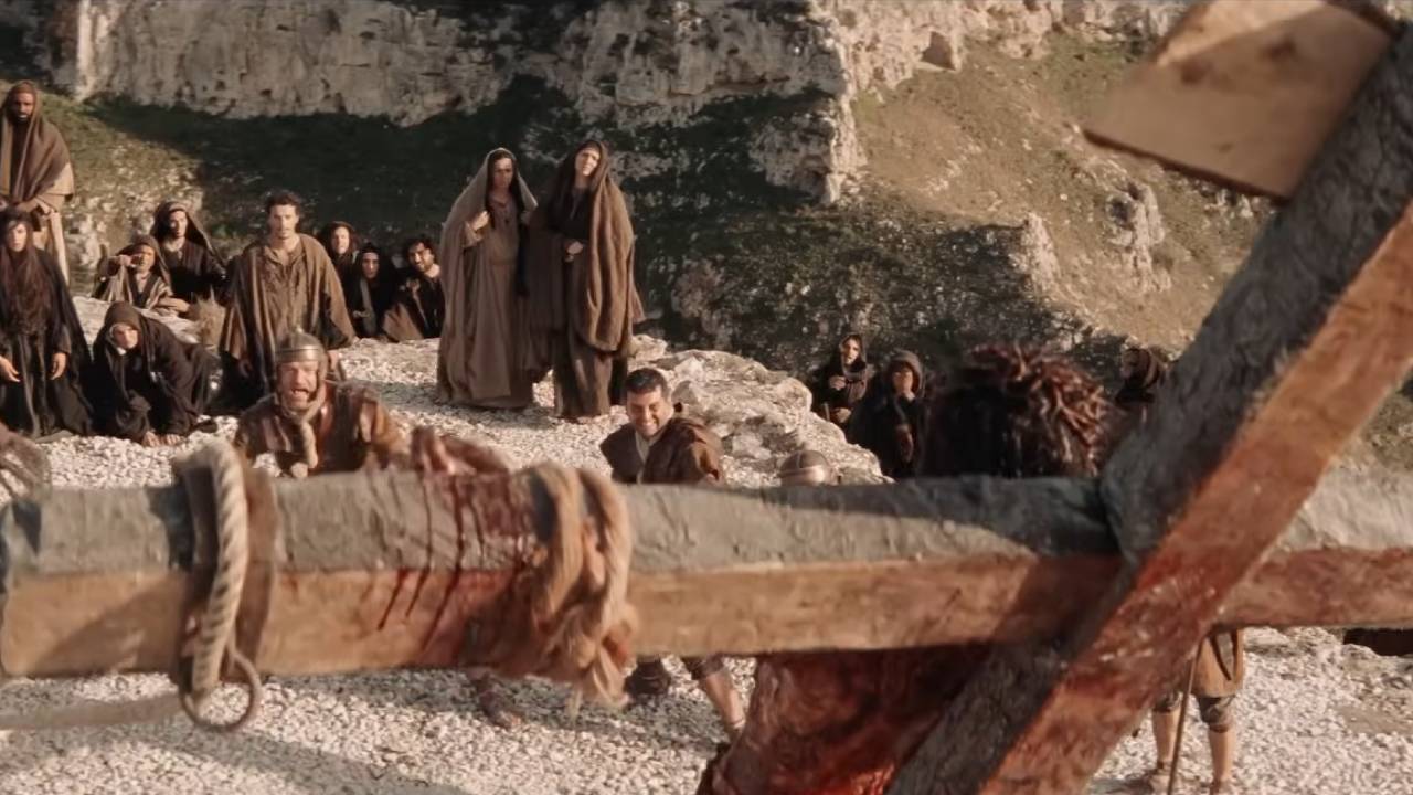 Behind Jesus on the cross, looking down on the people