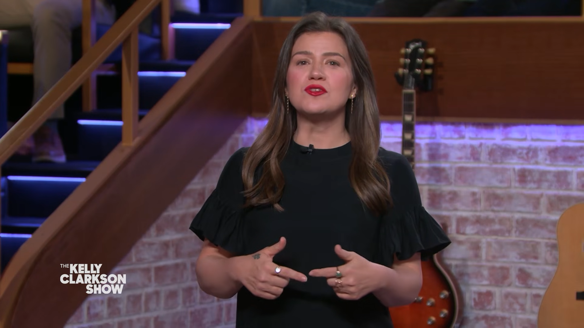 Kelly Clarkson standing and smiling