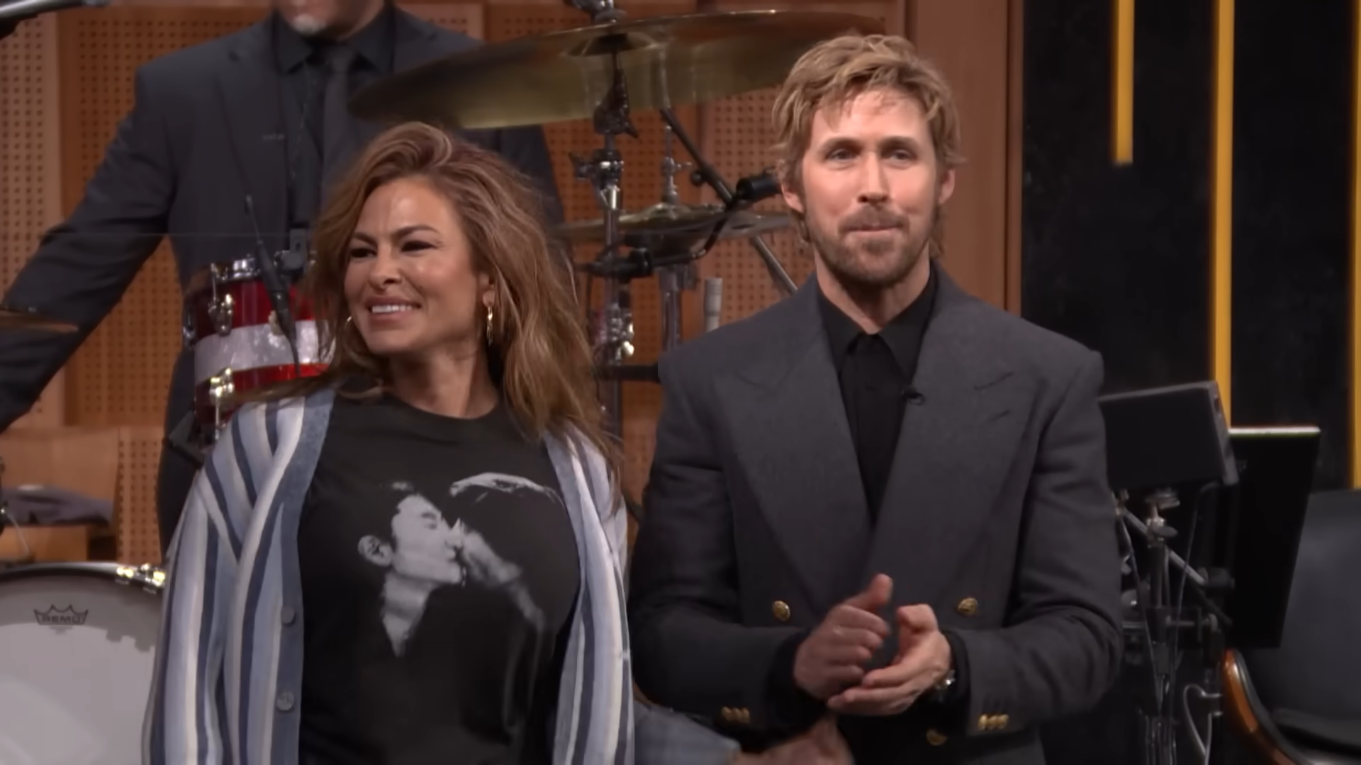 Eva Mendes laughs while Ryan Gosling stands beside her smiling
