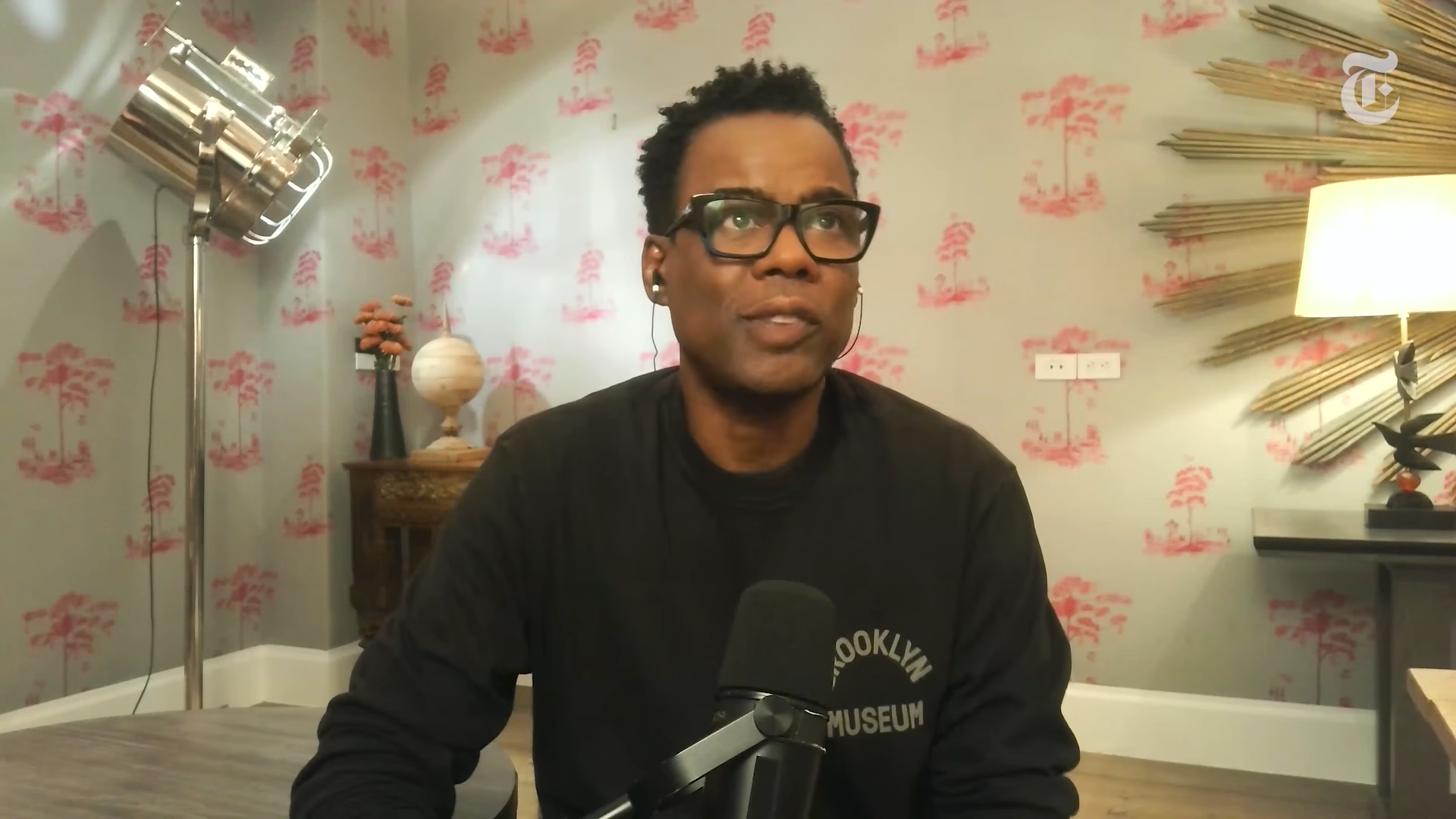 Chris Rock on webcam looking thoughtful