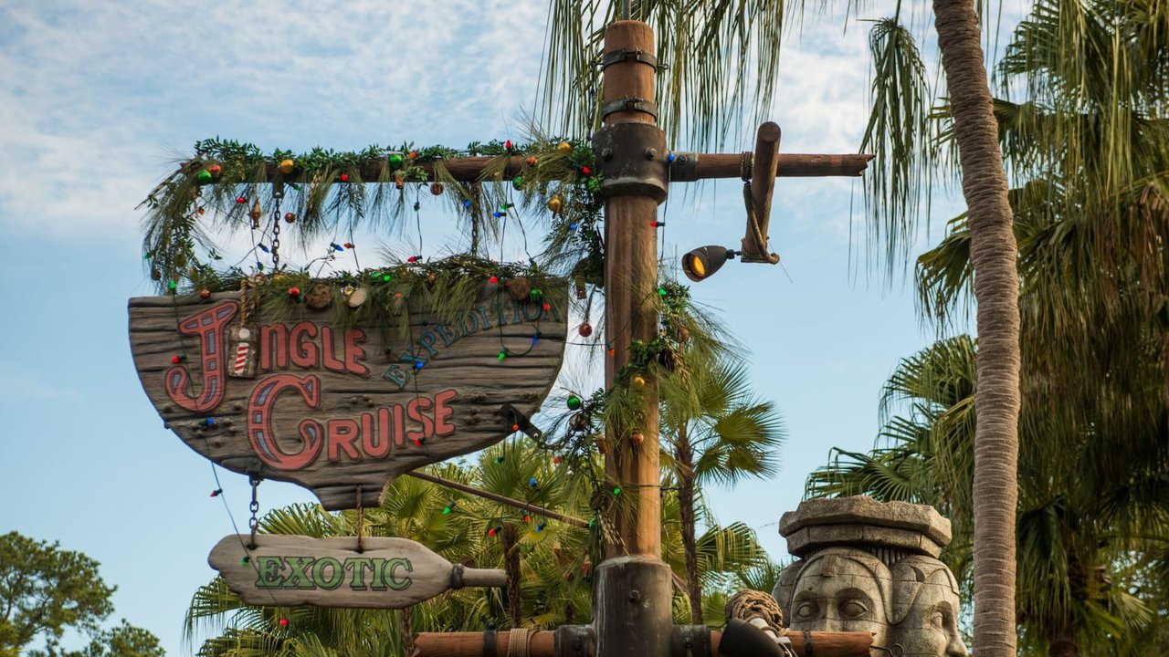 Jingle Cruise entrance sign wrapped in holiday garland in Adventureland at Magic Kingdom