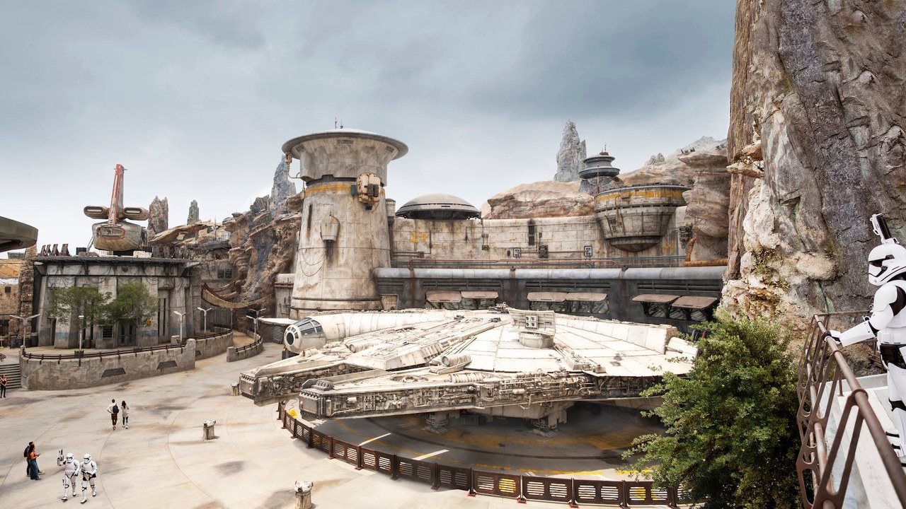 Wide view of Black Spire Outpost with the Millennium Falcon parked in the land at Hollywood Studios