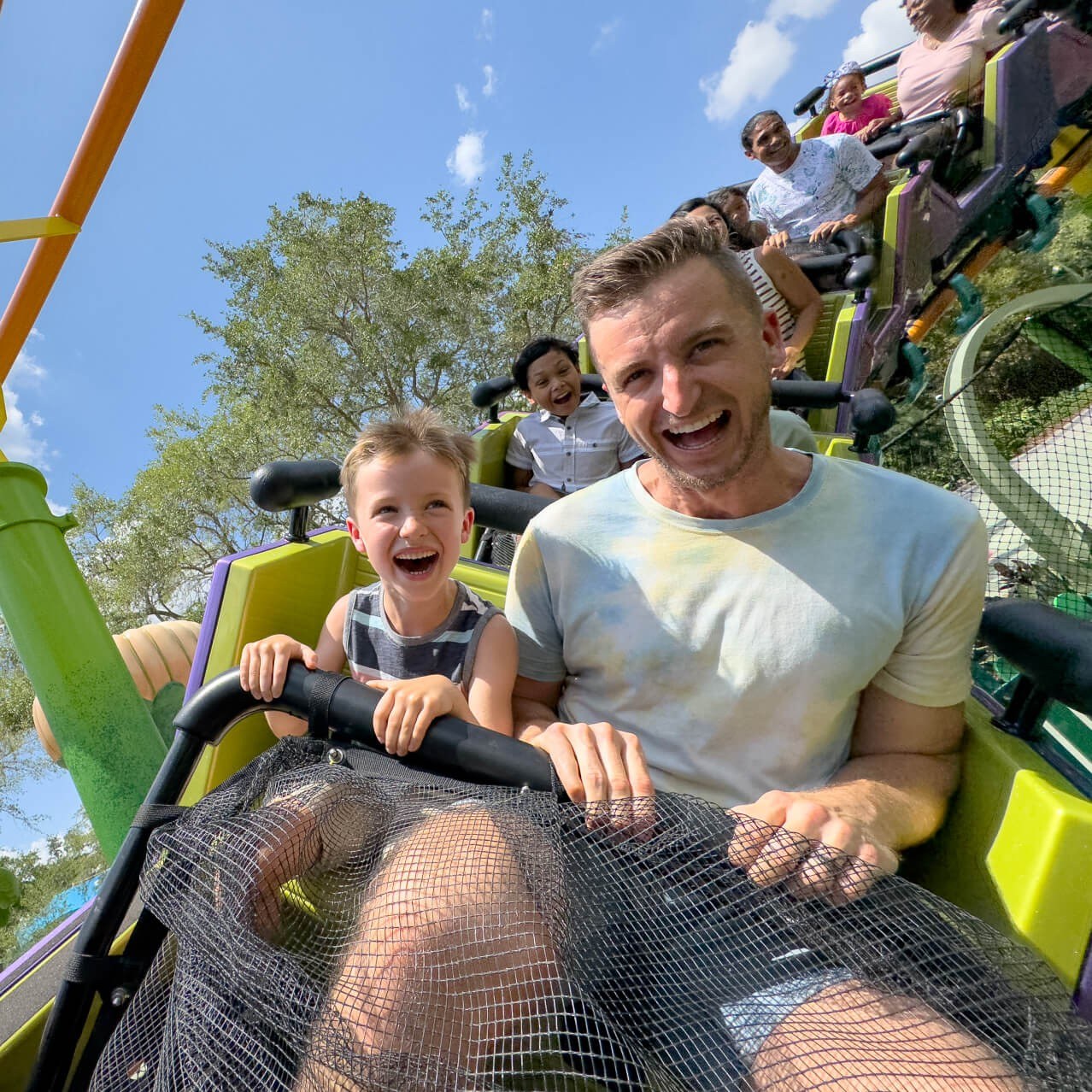 A father and son riding Trolls Trollercoaster at Universal Studios Florida