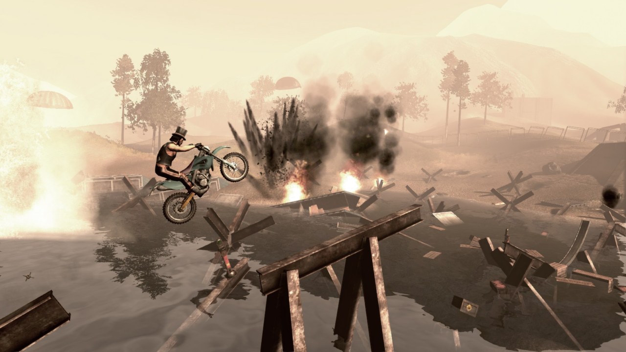 A motorbike rider jumps over a dusty desert course with wreckage in the background