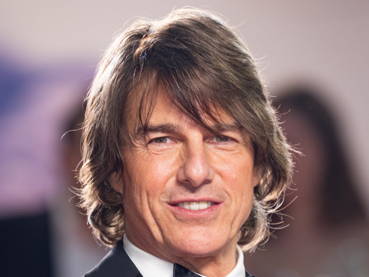 Tom Cruise smiling at the 2025 Cannes Film Festival