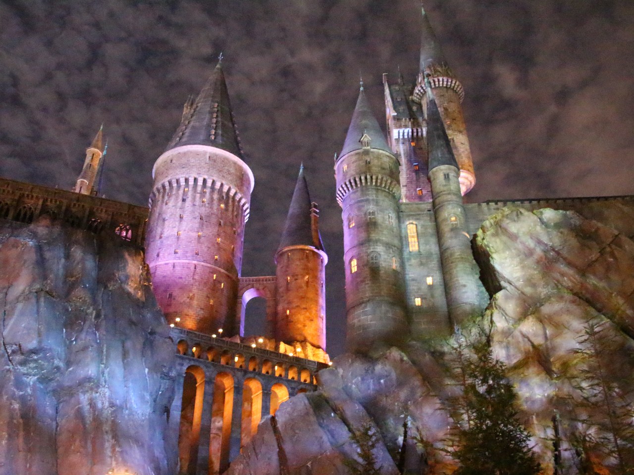 Hogwarts Castle lit up at night above Harry Potter and the Forbidden Journey