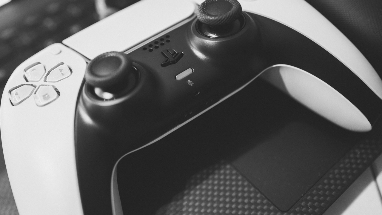 A white and black PlayStation 5 DualSense controller