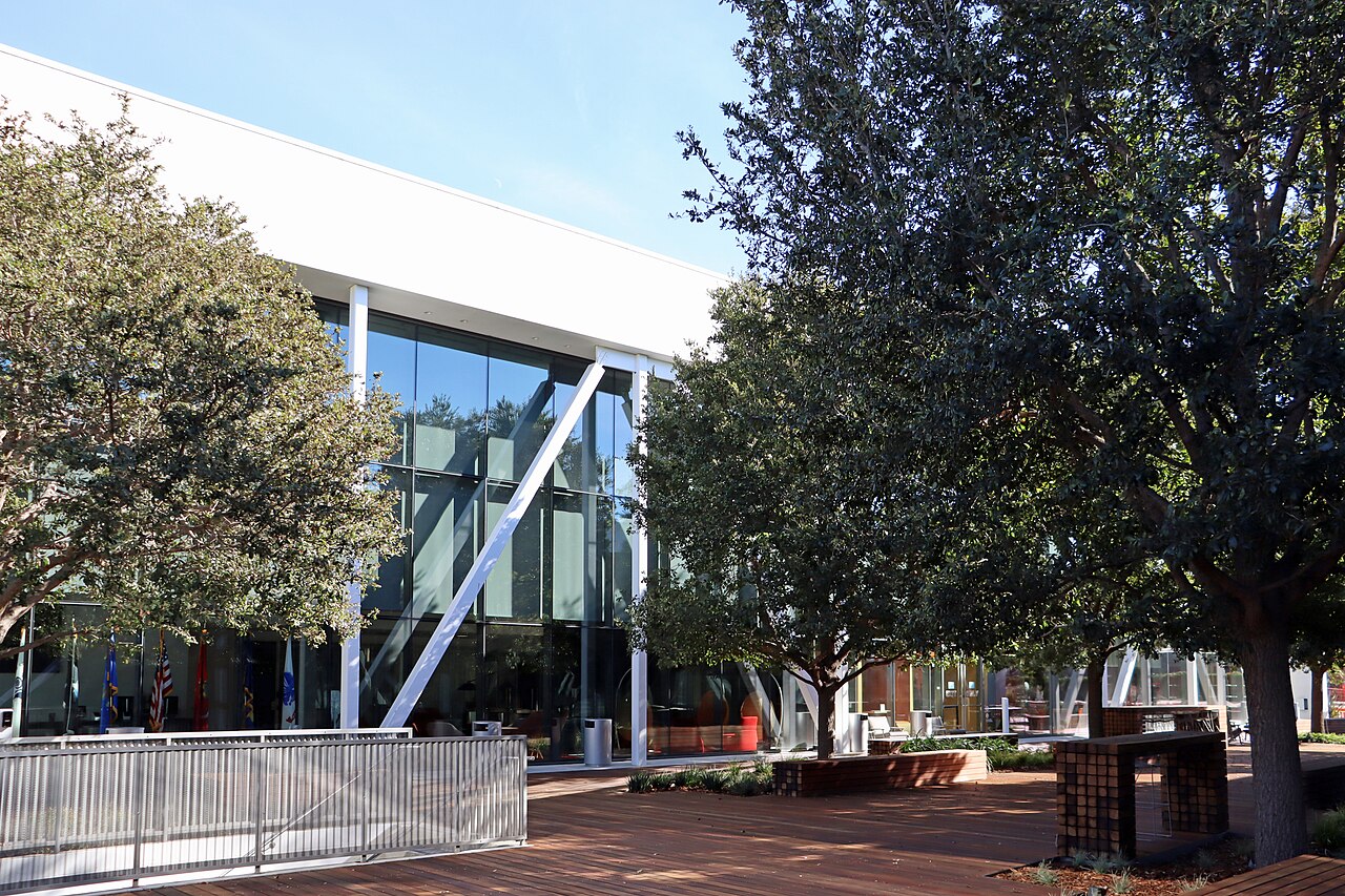 Glass-fronted office building at 2701 Olympic Boulevard surrounded by trees